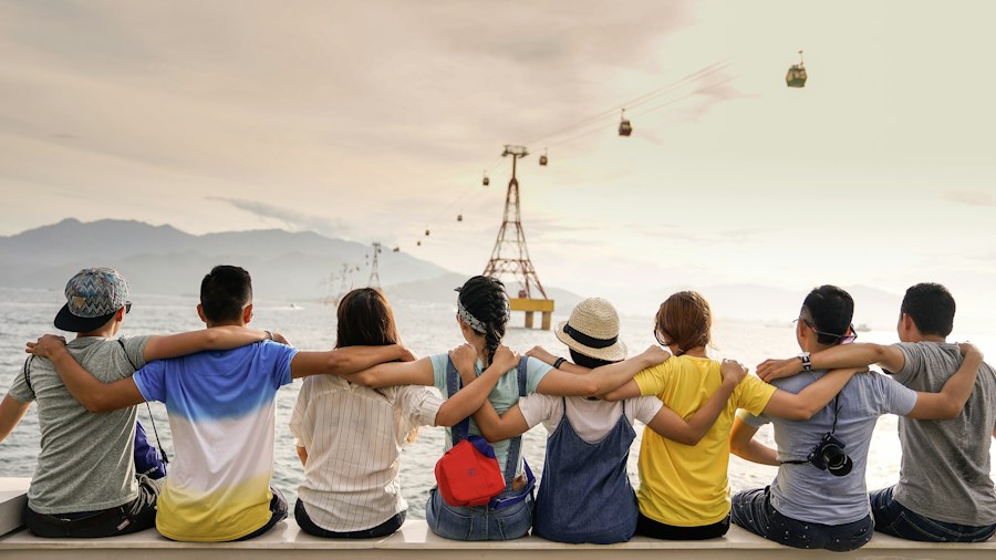 A group sitting together beside the water
