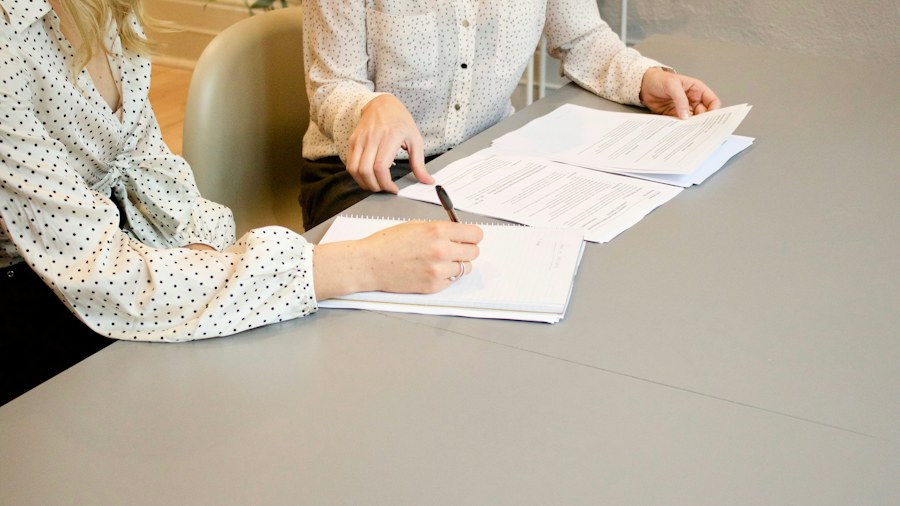 A person reviewing and writing on paperwork