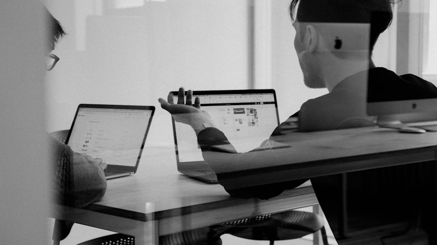 A person studying at a laptop beside a window