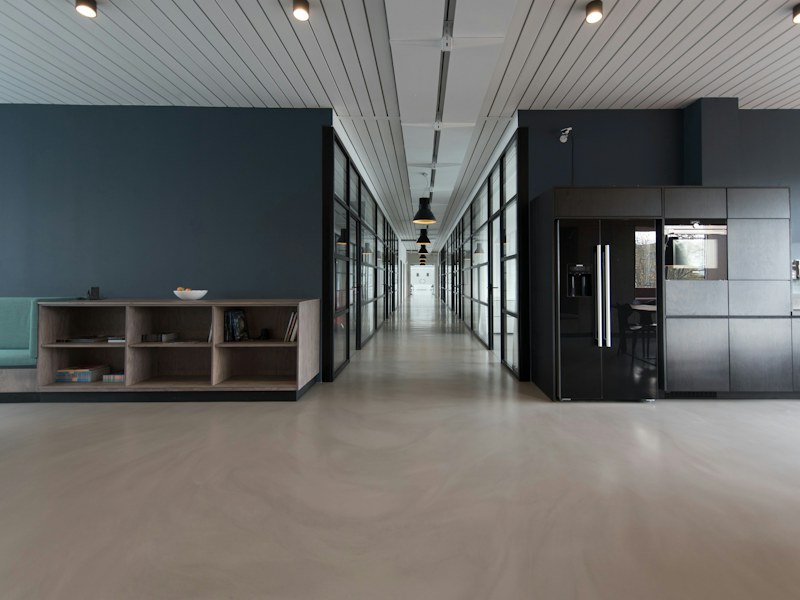 An organized workplace with meeting rooms and a shared corridor